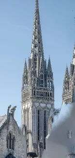 Gothic cathedral spires against a clear blue sky in a serene and architectural shot.