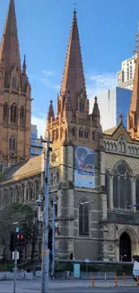 Gothic cathedral in an urban cityscape with a clear blue sky.