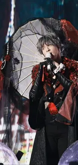 Gothic performer with parasol in red and black attire on stage.