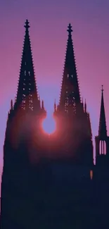 Gothic tower silhouette against a purple sunset.