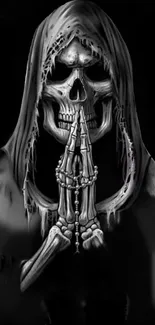 Gothic skeleton in hooded prayer pose on black background.