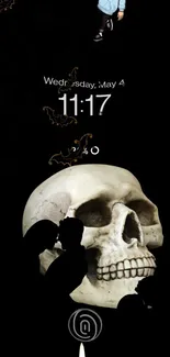 Dark mobile wallpaper with a gothic skull and silhouettes.