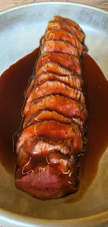 Sliced beef with sauce on a ceramic plate.