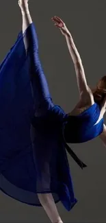 Ballet dancer performing in a flowing blue dress, captured mid-motion.