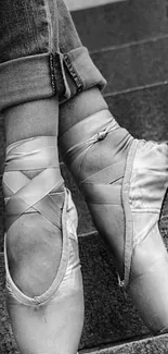 Ballet shoes poised on stair steps, grayscale.