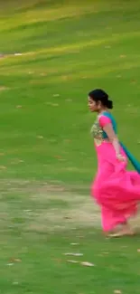 Woman in a colorful saree running in a green park.