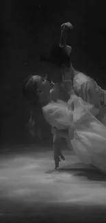 Elegant black and white dance duet in motion on a sleek surface.