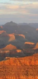 Stunning sunset over the Grand Canyon landscape with glowing orange hues.
