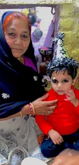 Grandmother holding child with festive hat, smiling warmly.