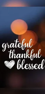 Grateful thankful blessed text on a bokeh dark blue background.