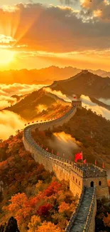 The Great Wall of China at sunrise with golden skies and autumn foliage.