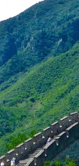 Great Wall of China with lush green mountains in the background.