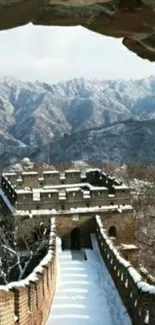 Snow-covered Great Wall with mountains.