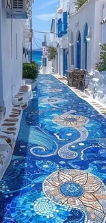 Colorful mosaic street in a Greek village with blue tiles.