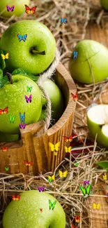 Green apples in a rustic basket with hay, perfect for phone wallpaper.