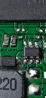 Close-up image of a green circuit board with detailed electronic components.