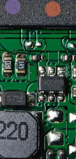 Close-up view of a green circuit board with electronic components.