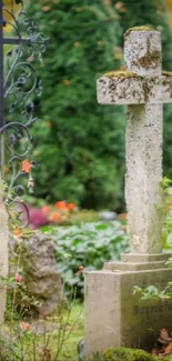 Stone cross in serene garden cemetery landscape.