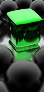 Luminous green cube surrounded by glossy spheres on mobile wallpaper.