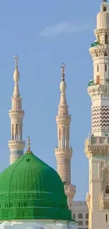 Wallpaper of mosque with Green Dome and minarets under blue sky.