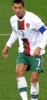 Football player in action on green field during match.