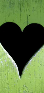 Green wood wallpaper with heart cutout.