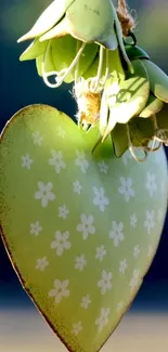 Green heart decor with white flowers, hanging elegantly.