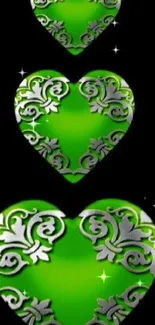 Green hearts with ornate design on black background mobile wallpaper.