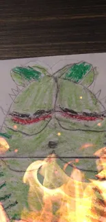 Hand-drawn green monster with fiery effect on wood background.