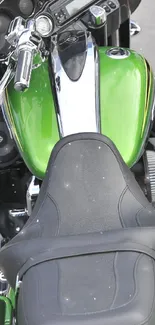 Close-up of a green motorcycle seat with chrome details.