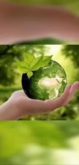 Hand holding a green Earth with leaves, symbolizing nature.