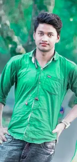 Casual portrait of a young man in a green shirt outdoors.