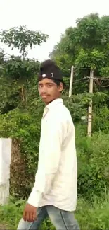 A man walking in a lush green landscape, creating a peaceful vibe.