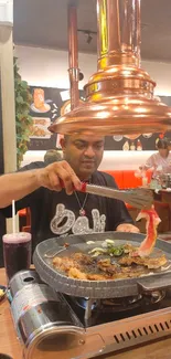 Man grilling meat in restaurant ambiance.