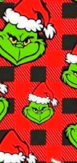 Grinch in Santa hat on red plaid background wallpaper.