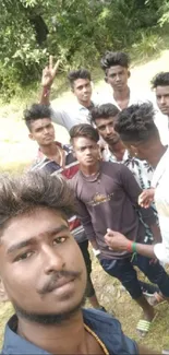 Group of friends taking a selfie outdoors in a natural setting.