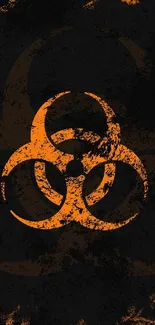 Grunge orange biohazard symbol on dark background.