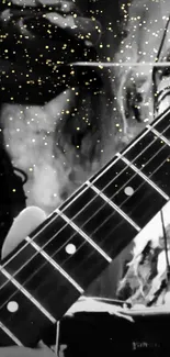 Black and white guitar with golden stars on wallpaper.