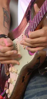 Close-up of hands playing an electric guitar, capturing live music action.