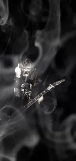 Guitarist performing with smoke in black and white.