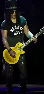 An iconic guitarist performs live with a yellow guitar, exuding rock vibes.