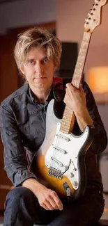 Musician with a vintage electric guitar in a warm and cozy room setting.