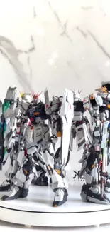 Gundam models on a white marble background with intricate designs.