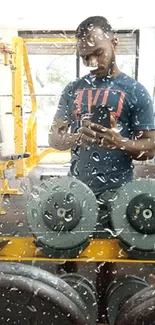 Reflective gym mirror with dumbbells and water droplets.