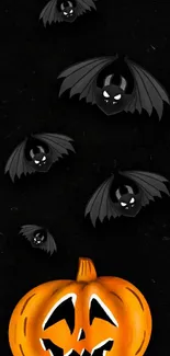 Halloween wallpaper with glowing pumpkin and bats on a dark background.