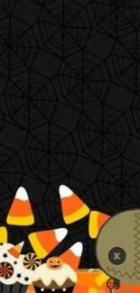 Halloween wallpaper with candy corn and cartoon character on black background.