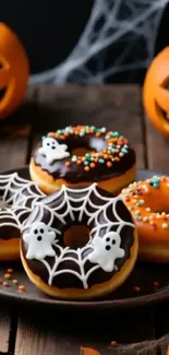 Halloween donuts with ghost and pumpkin decorations.