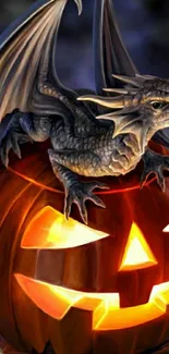 Mystical dragon sitting on a glowing jack-o'-lantern for Halloween wallpaper.