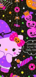 Hello Kitty in a witch costume with Halloween decorations.