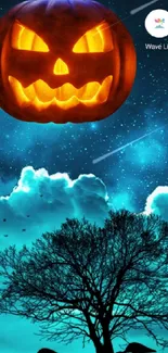 Mobile wallpaper of glowing pumpkin under starry sky with silhouetted tree.